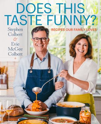 cover of Does this taste Funny by Stephen Colbert & Evelyn McGee Colbert. Looks like a normal couple taking a photo in the kitchen, then you notice shes pouring soup all over his hands.